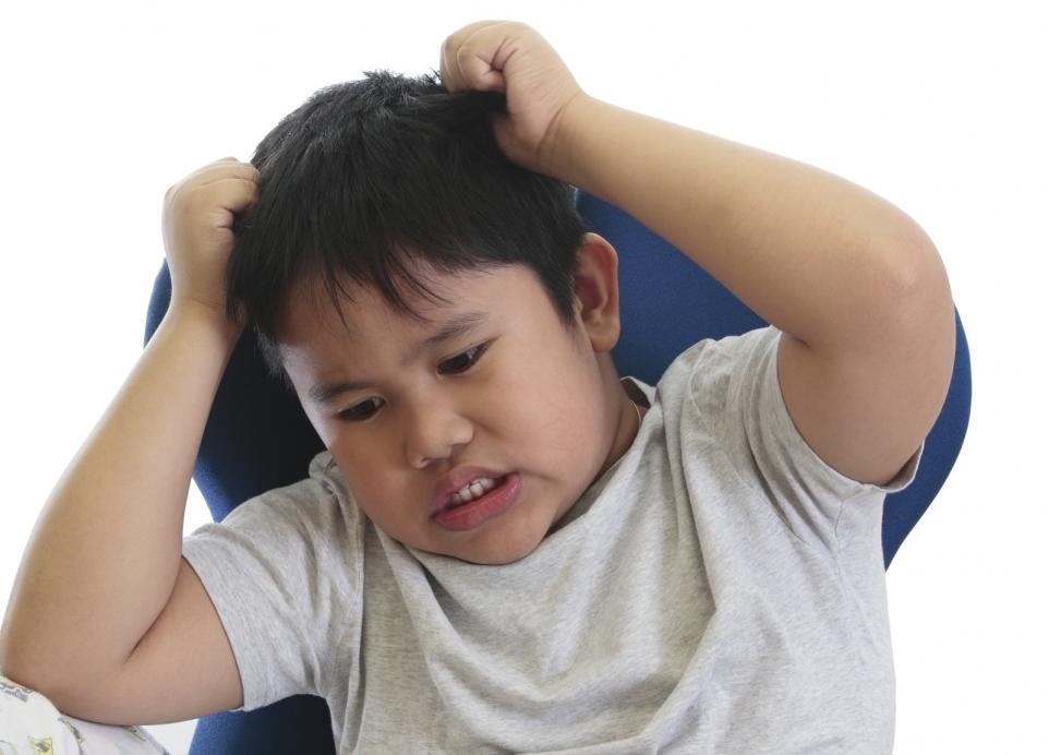 A boy suffers from lice