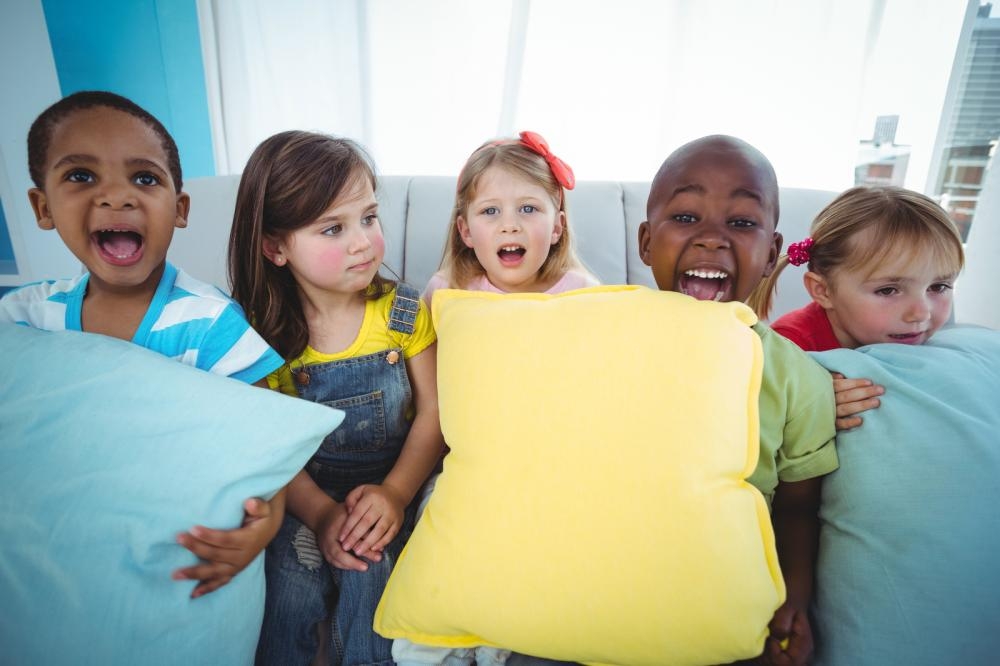 Happy children with pillows