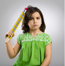 Little girl with big pencil